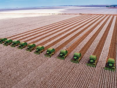 Correntina, Bahia, Brazil, February 26, 2019: Agriculture - Aerial image of several machines that harvest cotton straight in the field, with blue sky - Agribusiness