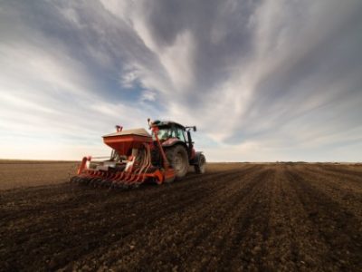 Farmer,With,Tractor,Seeding,-,Sowing,Crops,At,Agricultural,Field.