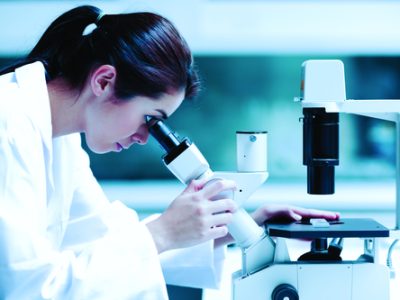 Scientist using a microscope in a laboratory