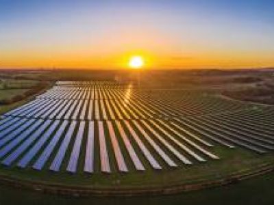 Panoramic of a solar farm at dawn taken from the air