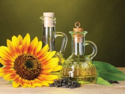 sunflower oil and sunflower on yellow background