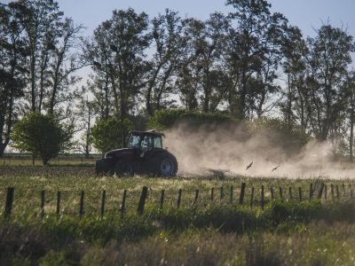 An amazing shot of a tractor working in a farmland